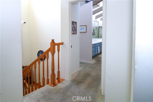 Upper hall with custom stair rails. View toward master suite.
