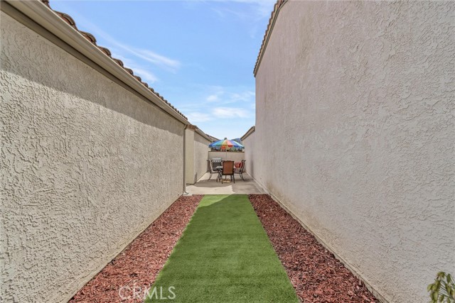 beautiful red bark/sod walkway to separate patio area off dining/living room