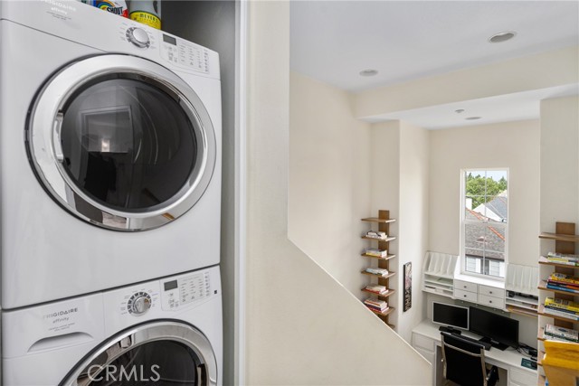 Stackable washer & dryer in laundry closet on bedroom level.