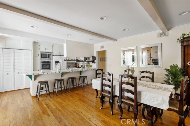 Casual dining at the breakfast bar - or formal dining at the table in this set up.  Laundry behind bi-fold doors at left.