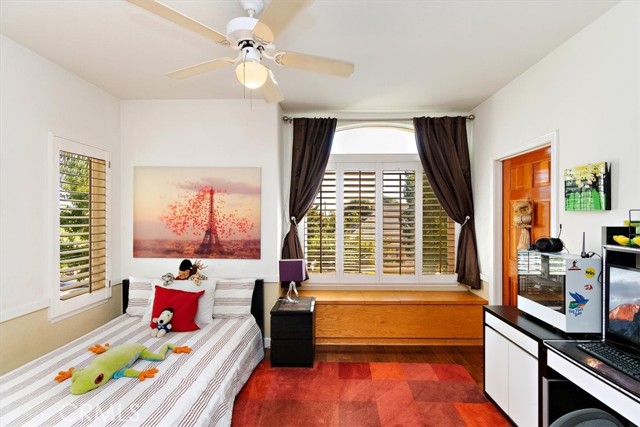 Upstairs bedroom with wood floors and walk-in closet