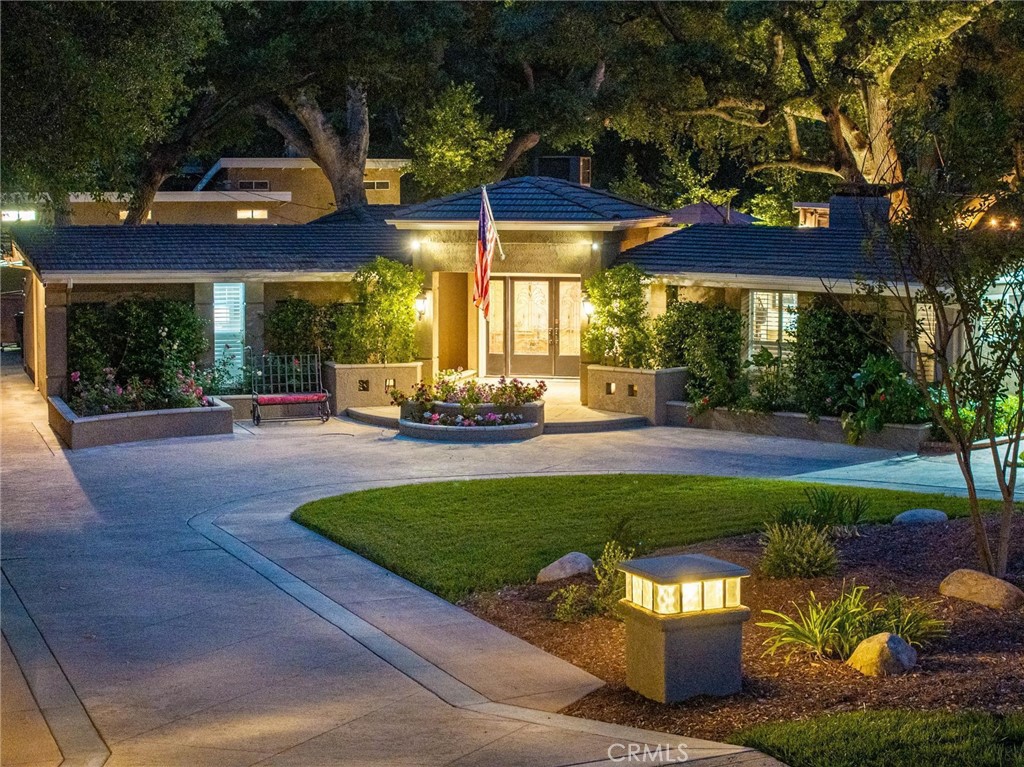 Heritage Lane – A One-of-a-Kind Happy Valley Gem Surrounded by Nature. Tucked into one of Santa Clarita’s most sought-after neighborhoods, “Heritage Lane” in Happy Valley Newhall is that rarely available, storybook location that people wait years to call home. The current owners were ready to make an offer the moment they pulled up, before even stepping inside, captivated by the set-back single story, large circular driveway, & nearly half-acre of flat, usable land filled with majestic 100+ year-old oak trees and lush, parklike landscaping. This home has that rare charm and welcoming presence. And once they discovered the ADU, complete with full kitchen, living room, bedroom, and bath, their love for the property only deepened. Ideal for guests, extended family, or a private studio, it’s a feature that makes this residence truly versatile. Over the past 14 years, the owners have meticulously upgraded the property, bringing out its natural warmth and rustic charm. They opened up the kitchen by adding a breakfast bar, remodeled both sitting rooms and enhanced two cozy gas fireplaces. Outdoors, they created an entertainer’s dream: a fully remodeled backyard with an extensive Lynx outdoor kitchen, featuring an extra-large BBQ grill, 2-burner cooktop, Tappan grill, 2-drawer fridge, plus wine barrel sink, storage, and trash bins. It even includes a powered barrel with projection for your favorite outdoor movie nights under the stars. Tasteful lighting and thoughtful landscaping complete the serene outdoor setting. Inside, the main house features 4 bedrooms, a spacious family room with fireplace, custom windows, beamed ceilings, skylights, and shutters, exuding an authentic and comfortable vibe. The updated kitchen showcases granite counters, stainless appliances, a center island, and more skylights that fill the space with natural light. The primary suite includes a retreat/office & dual walk-in closets. The 4th bedroom is currently used as an office (no closet). Additional features include a 2-car garage, ample parking for a boat or RV, and a brand-new main house A/C system installed in 2023. But truly, this property is about location... peaceful, scenic, and surrounded by nature, yet conveniently close to everything. With no HOA or extra taxes, this home is a rare find in Santa Clarita. A truly special place to live, entertain, & enjoy life. Welcome home.