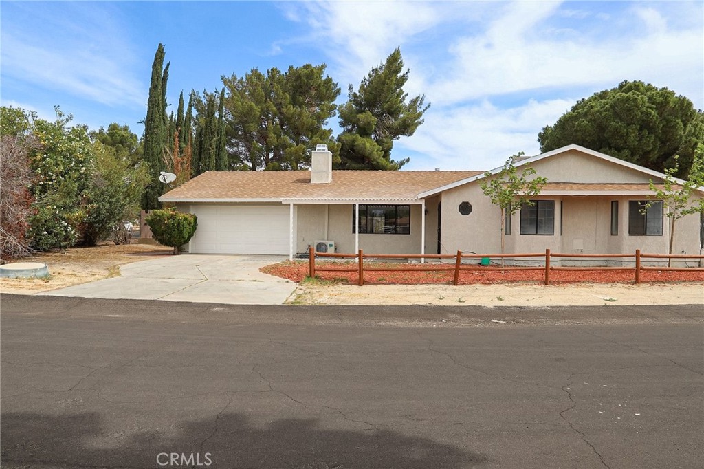 Welcome to this charming 3-bedroom and 2-bathroom home. Spread across 1,662 SQ. FT living area and 27,452 sqft lot size. Nestle in Lake Los Angeles, near Palmdale, Lancaster's downtown area. This property offers an ideal opportunity for those dreaming of space, this is a blank canvas for your renovation ideas, with spacious rooms, a flexible floor plan, and a generous yard that is perfect for possible expansion or creating your outdoor oasis with potential access for big toys, boat, RV possibilities are endless. The kitchen is ready for family Gatherings, offering ample space and easy access to the 2-car garage and laundry area. The dedicated dining area offers sliding doors giving you a view of the backyard and nature and giving you natural light. The spacious living room offers a brick gas fireplace for those cold days and large windows that allow natural light into the room. Next to the living room, you will find a den room that could be your home office or a playroom. The hallway will lead you to the first bathroom with a shower, next, is the main room and its bathroom, featuring 2 closets with ample space and sliding doors giving you a view of the backyard. The main bathroom features a dual sink, shower, and plenty of cabinet storage. Adjacent, you will find the other 2 rooms each offering ample closet space. The property is on a Septic tank, recently serviced, and has a 5-year-old A/C unit system. This property has chain link fencing.