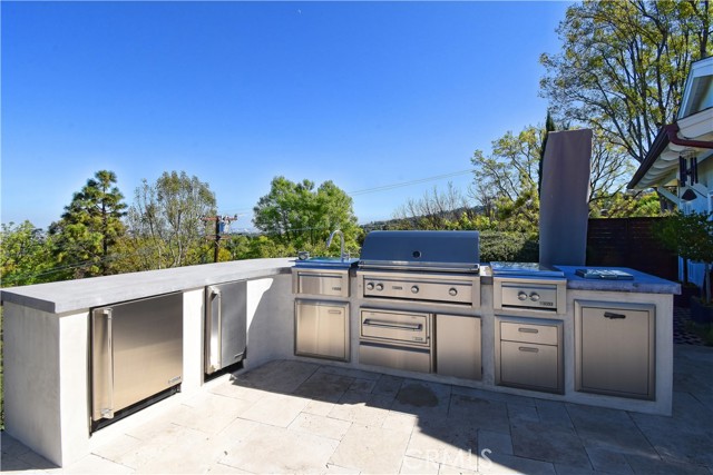 Outdoor kitchen with barbeque, refrigerator, ice maker, wok style burner - it has it all!