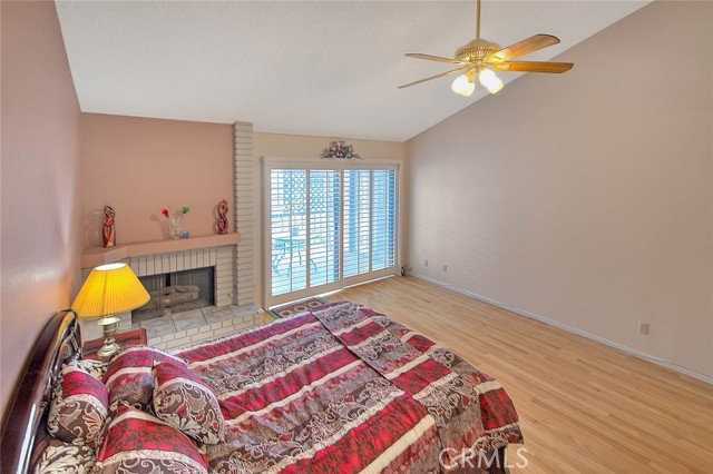 Another View Of Master Bedroom w/ Natural Gas Fireplace For Cozy Warmth.  Plantation Shutters To Second Floor Balcony For Evening Enjoyment!