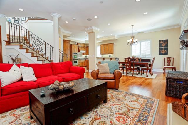 Beautiful stairway to the left with ornate iron railing and open floor plan shown with kitchen and living room- just perfect for entertaining. Beautiful stairway to the left with ornate iron railing and open floor plan shown with kitchen and living room- just perfect for entertaining.