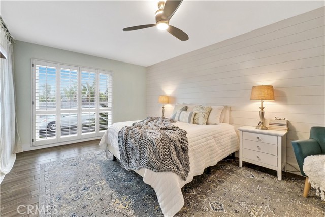 Large primary suite with shiplap accent wall