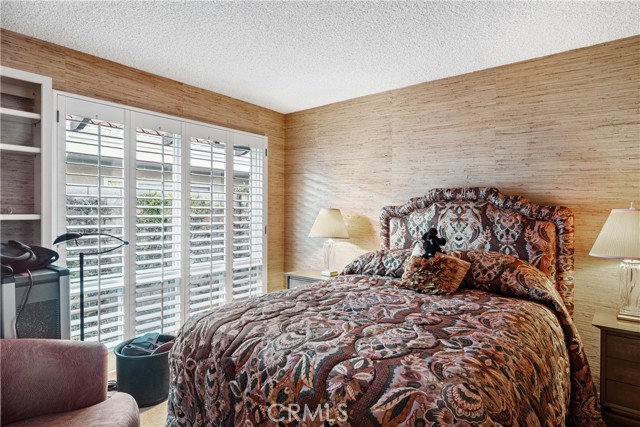 Bedroom #2 - Spacious, appointed with ornate wall-covering decor, and  plenty of closet space.