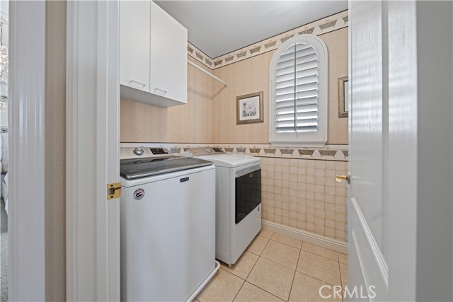 Laundry room so convenient! Located upstairs with sink and plenty of cabinets.