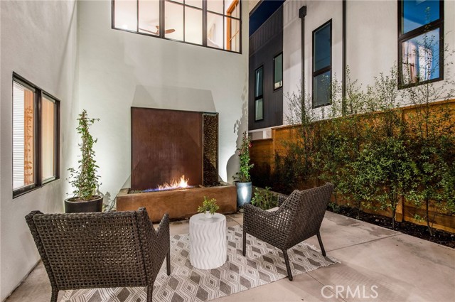 Relax by the fireplace outside in the courtyard.