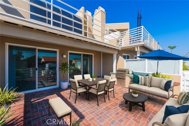 Virtually Staged- Large waterfront patio with built in grill and bar space.