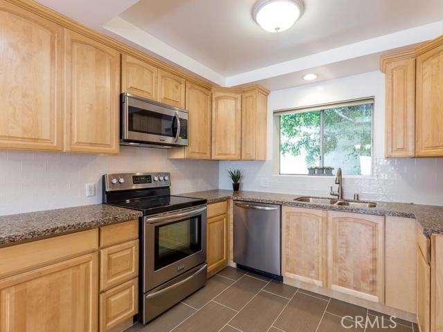 Remodeled kitchen, slate flooring, granite counters, stainless steel appliances, maple cabinets