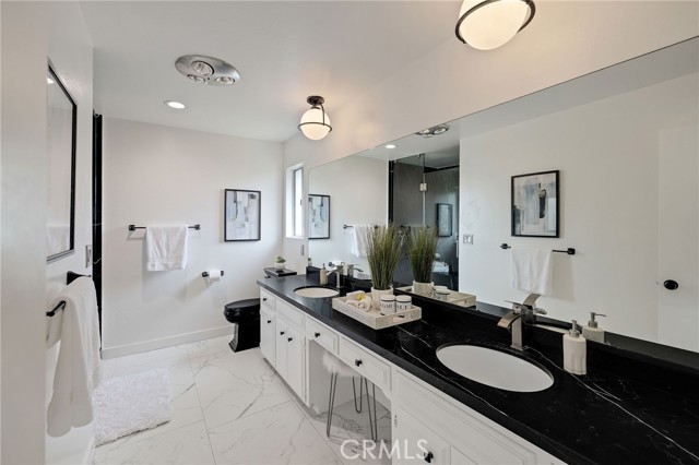 Primary Bathroom with Marble Countertops and Marble Floors