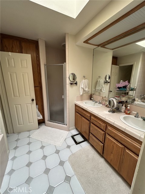 Primary bathroom, separate shower and bath, double sinks, sky light