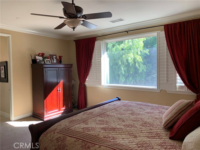 Master bedroom, facing the bathroom, with the hillside view and morning sun.