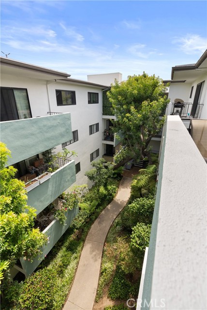 Winding lush pathways through center of complex lead to pool and koi pond.