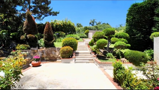 Lush landscaping, waterfall and pond in front private yard