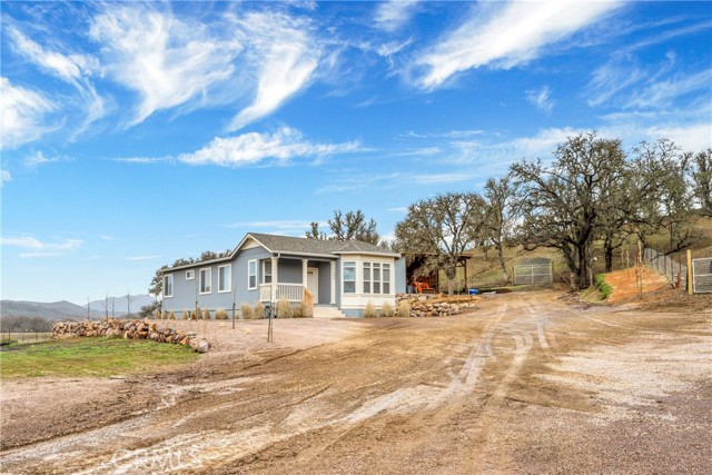 Enjoy the seclusion of a quiet country setting at this quintessential Lower Lake Ranchette! 10 sprawling acres with an immaculate manufactured home that includes 3 bed / 2 bath with 1,455 SF, built in 2019. Enter through the automatic gate to your fully fenced & cross fenced property- including NEW 6' fence & gates along the perimeter, 2 pastures & 3 horse corrals. A pasture shed + 16x24 ag shed for all of your storage needs! Enter the home to find a spacious and open floorplan, 9' ceilings with recessed lighting, upgraded coffered ceiling detail in the living room + primary suite &
beautiful valley views throughout the windows of this special home. The kitchen includes a large island, upgraded stainless steel appliances & cabinets with soft close hinges. Enjoy dining at the breakfast bar or formal dining area with a view! Spacious indoor laundry room with additional storage. The primary suite with ensuite bath includes a large walk-in closet. 24 KW Generac generator is a thoughtful upgrade in case of a power outage. Seamless gutters with drainage away from the home. Special attention was given to the landscape design at this property. Tree lined entry & shrubs for privacy along 2 perimeters & drought tolerant landscaping throughout. Gravel throughout for parking and easy equipment use. 2 RV hook-ups (30 & 50 AMP) - great for visitors! Convenient central location, roughly a mile off highway 29, with easy access to local attractions such as wineries, shopping, grocery, coffee shops, lake activities and more! Country living at its finest!