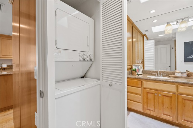 Stackable washer/dryer in bathroom closet.