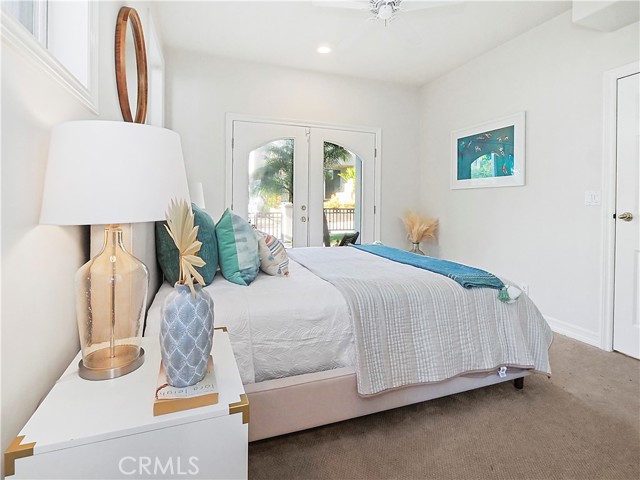 bedroom 3 with private bath and private french doors overlooking grassy yard