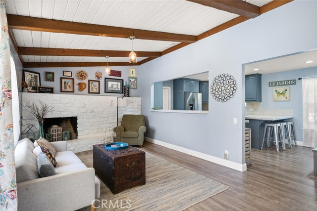 Living Room w/ Beamed Ceiling and Rock Fireplace