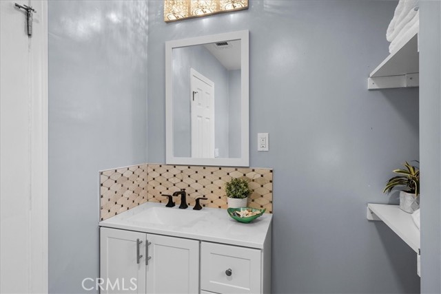 Upstairs full bathroom vanity and storage.