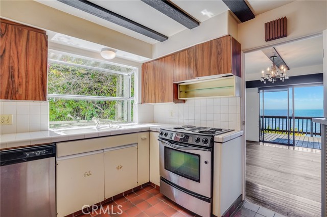 Kitchen and separate dining room that opens up to ocean view deck.