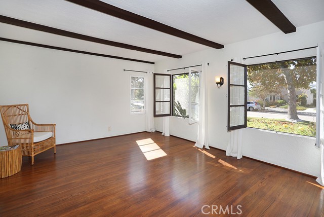 You’ll immediately notice upon entry the large entertaining area. The living room and dining room are large, quite spacious. Notice the beautiful French mullion windows throughout, they are in excellent condition, they were refurbished in 2021. Of course, the beamed ceiling and vintage sconces add to the charm.