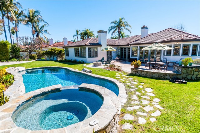Beautiful pebble tech salt water pool & jacuzzi.  Large BBQ island and firepit is great for family parties and entertaining!