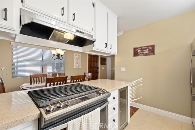 Well appointed kitchen with stainless steel appliances and quartz countertops