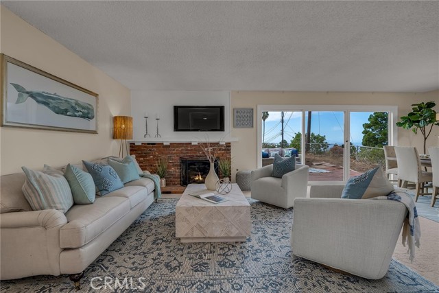 Sunny and bright living room with brick fireplace