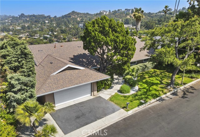 3546 Caribeth Drive Encino, California Jetliner views & Mid-Century charm in Encino Hills! Step through your double-door entry opens to classic Terrazzo flooring that opens to the formal dining area and 3 living rooms of views to the east valley! Patio enclosed by previous owner adds another 400 feet of living space to the home---and more views! While some cosmetic updates may be on the wish list, this homes' solid structure and pride of ownership shine through. Enjoy peace of mind with a newer roof equipped with owned solar panels (not leased), and a recently remodeled eat-in kitchen featuring shaker-style cabinetry, sleek stainless steel appliances, and stylish tile backsplashes. Modern upgrades include a tankless water heater and a newer HV/AC system--ensuring comfort and efficiency year-round. With a lot that's 30,998 feetprivacy is insured. Located in a sought-after neighborhood served by top-rated LAUSD schools such as Lanai Road Elementary and Hesby Oaks Charter, this home offers not only timeless design but also an unbeatable location.