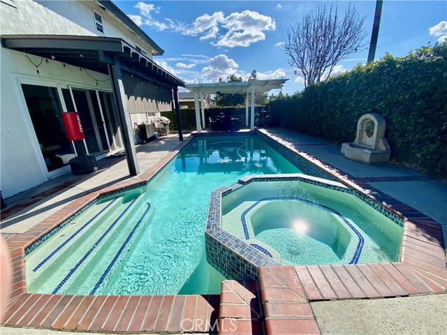 Resort style swimming pool with hot tub