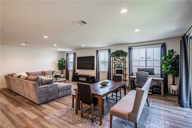 Family room side of the great room with 3 windows that have breathtaking views, and recessed lighting above makes this space filled with light. Pocket sliding glass door on the right of pictture.