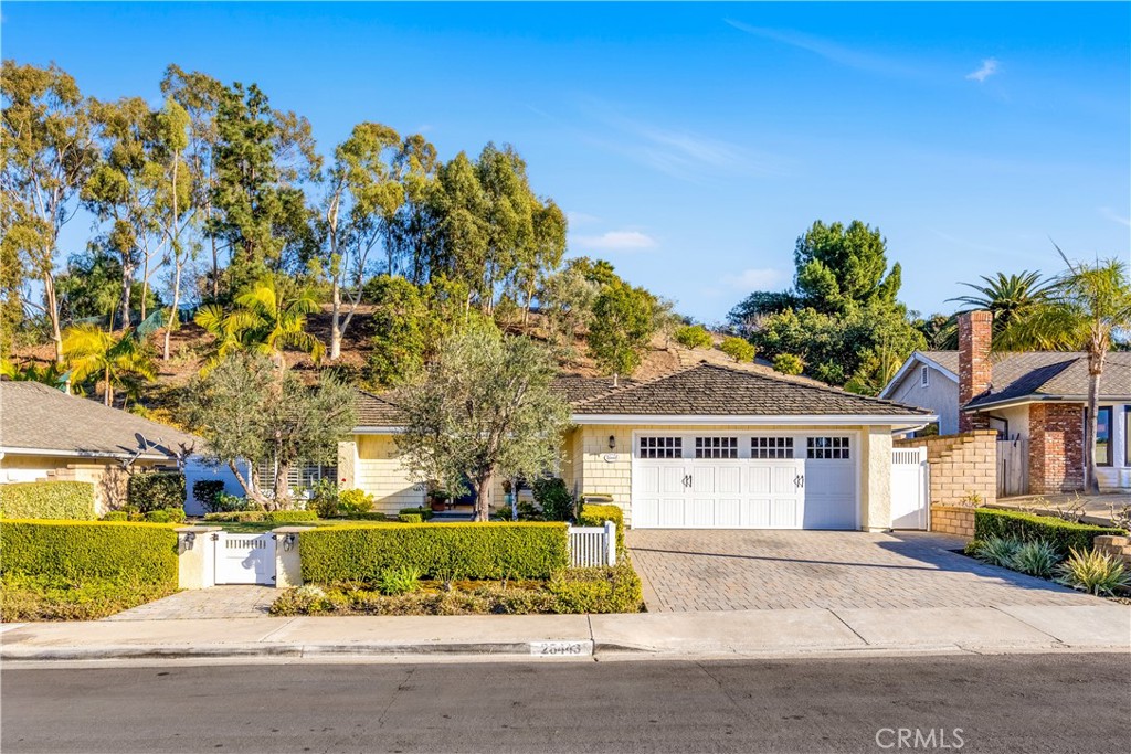 Step through a charming Dutch door into this expanded and remodeled Niguel Hills ranch home. This light and bright single-level open floorplan features 3 bedrooms, 2 baths, living room, dining room, family room, fully appointed kitchen with nook and pantry, interior laundry room and 2-car garage. This home has been impeccably maintained and features fireplaces in the living and family rooms, wainscoting throughout, wide window shutters, skylights, caesarstone countertops, hardwood floors and recessed lighting. Energy features include a tankless water heater, a new electrical panel, and PEX piping. Step to the backyard and enjoy a wraparound patio with an outdoor fireplace and plenty of space for a table and chairs and several sitting and play areas. The home sits on over a quarter acre. In addition to a deep backyard, the hillside behind is planted with succulent plants and olive trees. NO HOMEOWNERS' ASSOCIATION. Located in the heart of Laguna Niguel, this home provides easy access to the freeways, regional park, shopping, restaurants, Dana Point Harbor, and beaches. This turnkey cottage offers a cozy and comfortable lifestyle blending timeless elegance and functional design.