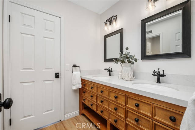 Upstairs secondary bathroom with custom vanity and dual sinks!