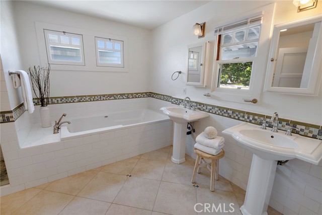 Primary Bathroom with double vanities and a jetted tub.