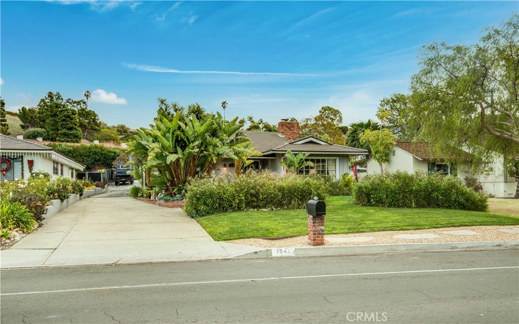 This open and airy updated 3 bed/3 bath home sits on a 10,000+ SF flat lot in highly desirable Lunada Bay, directly across from the PV trail and all it has to offer. You’re just a short walk to all three schools, the ocean bluffs, the famous LB baseball fields, the LB Market and other shops & restaurants of the LB Plaza.  The lushly landscaped front yard hides a cozy patio/sitting area with brick firepit that leads to the entry of a well-kept home with beautiful wood flooring.  The living room features a wood-burning fireplace and large windows that let in plenty of natural light. Walk from living room to the spacious dining area which opens to a spacious family room and kitchen with breakfast bar, stainless appliances and lots of cabinets for storage.  The family room has vaulted, wood beamed ceiling, fireplace, and sliding glass doors that lead to a beautiful patio with plenty of space for seating, outdoor kitchen, and TV for relaxation or entertainment.  3 large bedrooms including Master with built in shelves, plantation shutters, and updated master bath.  Detached 3-car garage with one finished space that can be used as a studio, office, or guest room.