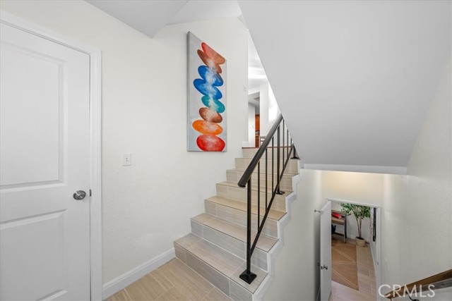 Front door entry, leading up to main level living room and kitchen area. Leading down to bonus room and attached 2 car garage entrance.