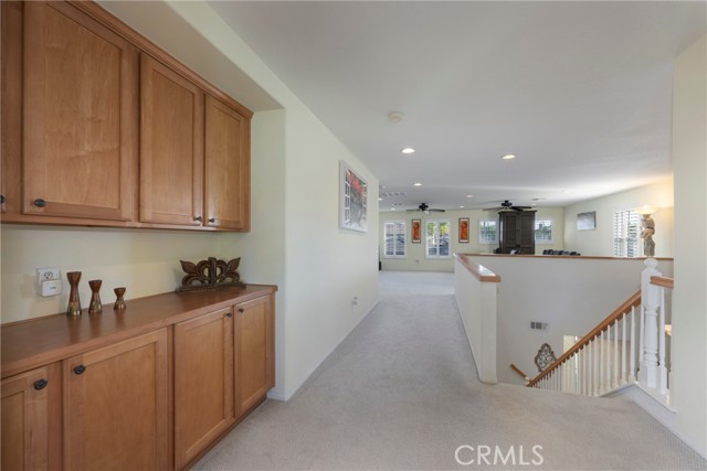 Top of the stairs, looking from the Master toward the loft and bedrooms. The entire upstairs has newer carpet.