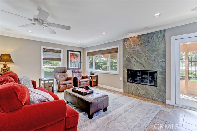 Elevated Wood-burning Fireplace with Floor-to-Ceiling Rain-Forest Marble