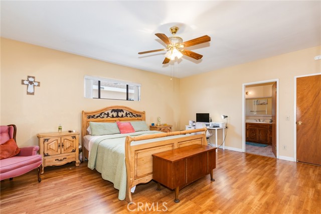 Large bedroom with ceiling fan and private bathroom