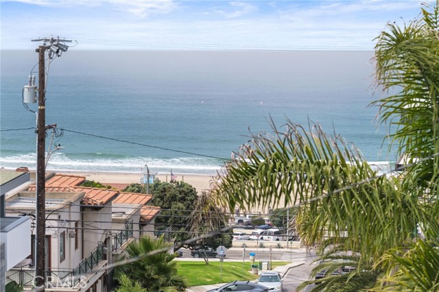 Top deck views of ocean, white water and dry sand.