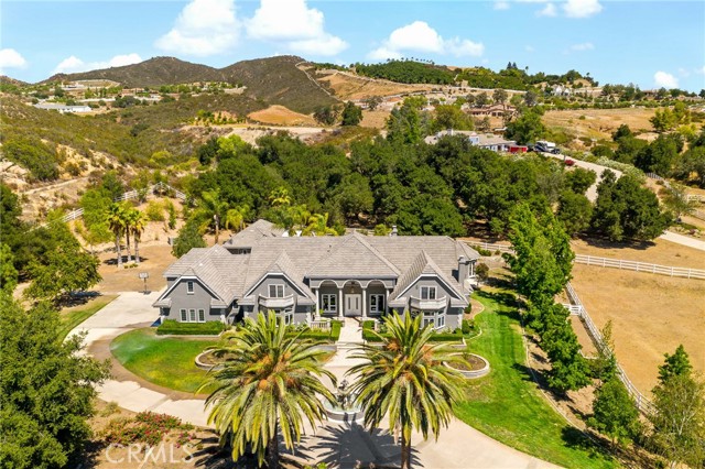 ***The Perfect Equestrian Estate*** Come discover a majestic property situated on 5.83 acres of flawlessly manicured grounds! An extensive equestrian facility located in Southern California's premier horse country (La Cresta) awaits you and your prized equine collection. Behind the private gates you ‘ll be graced by a tree-lined driveway that leads to a circular drive. The main residence offers 5 bedrooms and sprawling living spaces! A master suite is on the main floor and features a library, workout room and easy access to the back patio. You’ll also find a private ensuite featuring only the finest stone, cabinetry along with soaking tub, rainfall shower and a closet built for king and queen! A chef’s kitchen is equipped with high-end appliances and has a massive counter with split-level bar seating as well as a center island- all adorned with gleaming granite counters. This area flows seamlessly to the family room and offers easy access to a covered patio- ideal for hosting huge social gatherings.  A one-bedroom guest house can easily be converted to a two bedroom and features the same high end finishes as the main house. The pool and spa are center stage in the backyard and the space offers plenty of seating areas as well as a covered veranda with a separate barbecue area. An epic 12-stall barn has roomy living quarters, and fully outfitted with wash and tack rooms misters and more!. You’ll also appreciate  the large riding arena, pastures and hot walker, plus this property has easy access to the many horse trails that exist here! This is a MUST SEE! Welcome home!