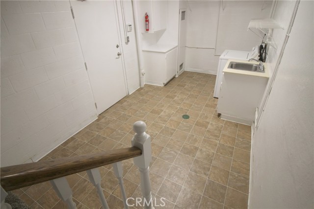 Spacious laundry room w/new flooring leading to garage