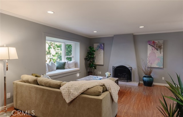 Living room with bay window, window seat, and fireplace