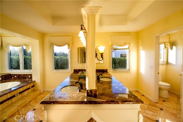 His and Her Master Bath with nice tile upgrades on floor and granite counter tops.  Full bath and a shower.