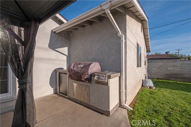 BBQ island with built in mini refrigerator.