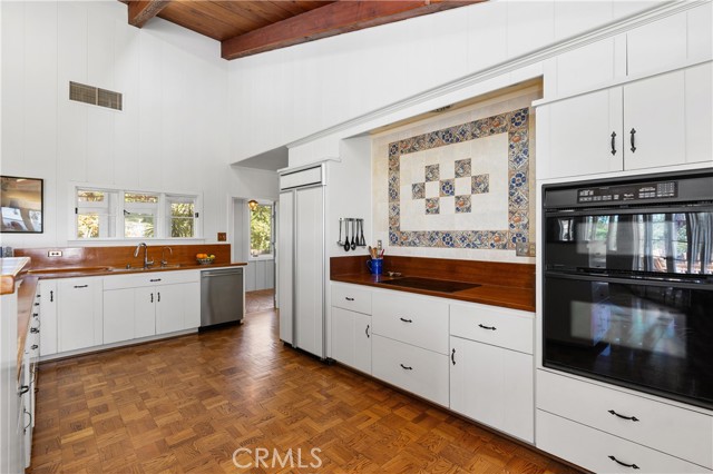 The kitchen features wood floors, mahogany counters and plenty of storage.