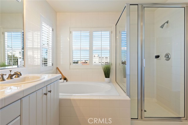 Owner's bath with soaking tub and stall shower.